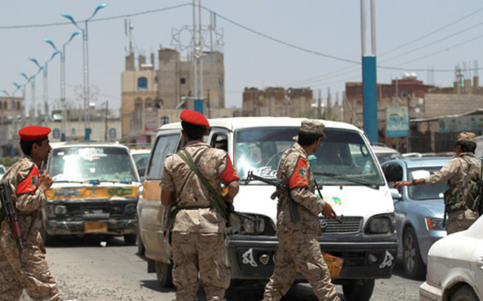FILE: Yemeni soldiers stand guard in the capital Sanaa on 20 April, 2014, as they check passing vehicles as authorities tightened security measures. Picture: AFP.