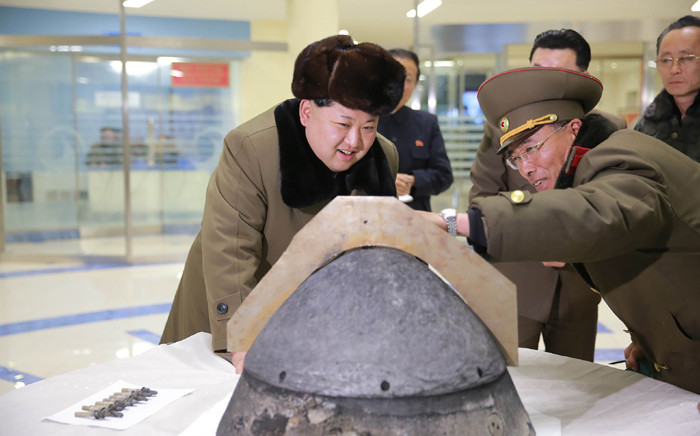 FILE: North Korean leader Kim Jong-Un being briefed during an atmospheric re-entry environment simulation of a locally manufactured heat-resistant section of a ballistic missile warhead part at an undisclosed location in North Korea. Picture: AFP.