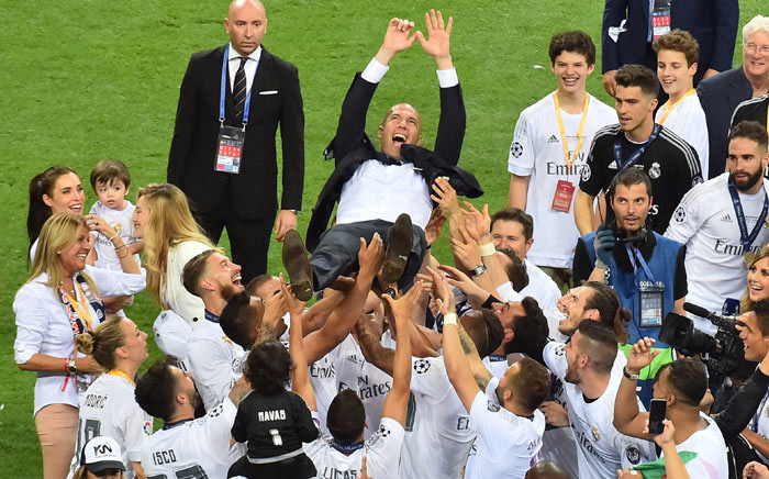 Real Madrid's French coach Zinedine Zidane is lifted by his players after Real Madrid won the UEFA Champions League final football match between Real Madrid and Atletico Madrid at San Siro Stadium in Milan on 28 May 2016. Picture: AFP