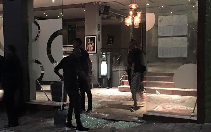 Staff members of the Orbit jazz club clean up after a group, believed to be protesters, vandalised the popular club on Friday 14 October 2016. Picture: Aymeric Peguillan/Facebook.