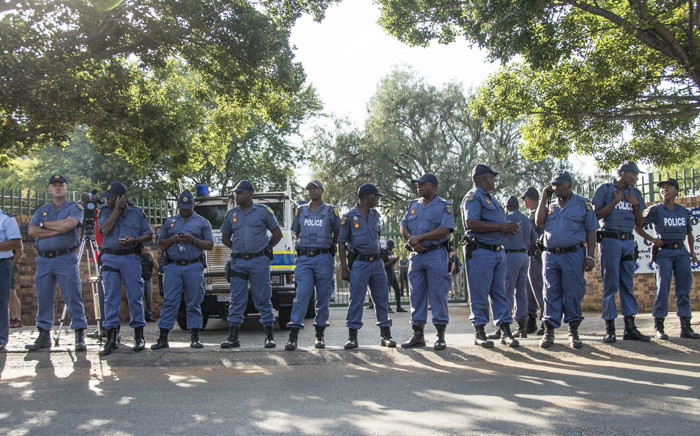 Police officers guard the Hoerskool Overvaal on 17 January 2018 following protests over an admissions row between the school and the Gauteng Education Department. Picture: Ihsaan Haffejee/EWN