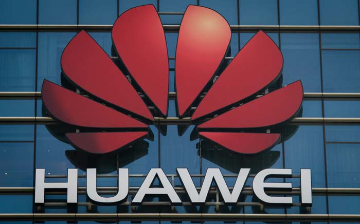 FILE: The Huawei logo stands on a Huawei office building in Dongguan in China’s southern Guangdong province on 18 December 2018. Picture: AFP