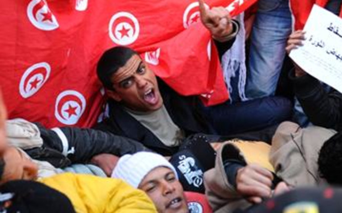 Inhabitants of the central Tunisia region of Sidi Bouzid chant slogans during a demonstration in front of the Government palace in Tunis. Picture: AFP.
