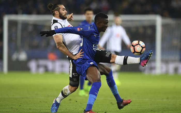FILE: Leicester City's Ghanaian midfielder Daniel Amartey (R) tries to hold off Derby's English midfielder Bradley Johnson (L) during the English FA Cup fourth round replay football match between Leicester City and Derby County at King Power Stadium in Leicester, central England on 8 February 2017. Picture: AFP.