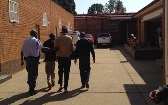 Police escort two of the three men to the Fochville Magistrate’s Court arrested in connection with the shooting in the Mpahla village in Fochville, south of Johannesburg. Picture: Jacob Moshokoa/Eyewitness News.