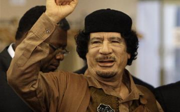 Libyan leader Col. Muammar Gaddafi gestures as he enters the U.N. headquarters for the UN General Assembly on 23 September 2009. AFP