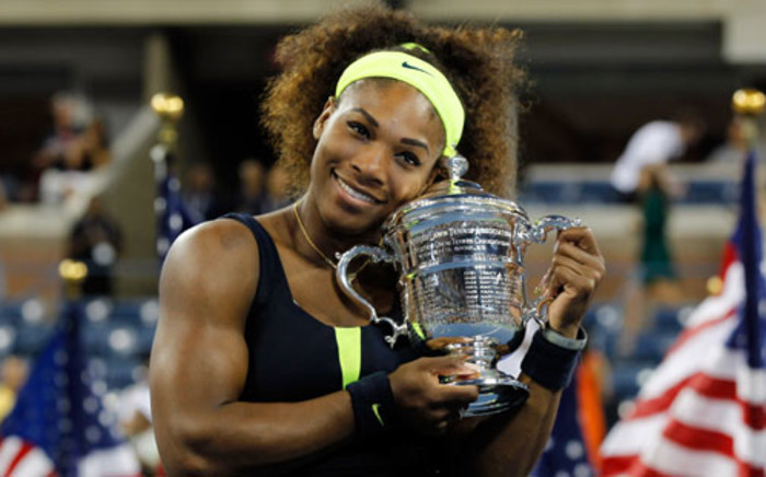 Serena Williams of the United States hugs the championship trophy after defeating Victoria Azarenka of Belarus to win the women's singles final match on Day Fourteen of the 2012 U.S. Open. Picture: AFP.