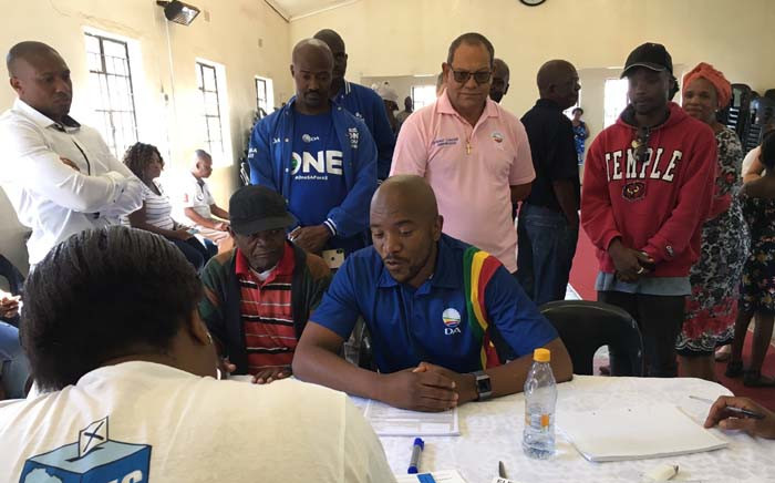 DA leader Mmusi Maimane checks his voter registration details at the Presbyterian church in Soweto. Picture: Katleho Sekhotho/EWN.