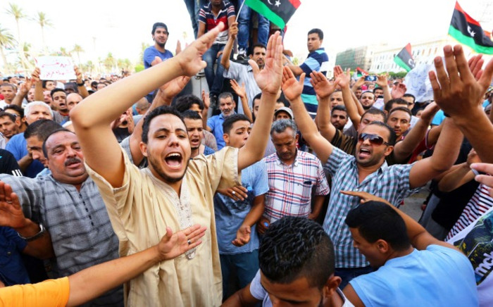 Libyans take part in a demonstration in the capital Tripoli on 31 July 2014, calling for international intervention to protect civilians. Picture: AFP.