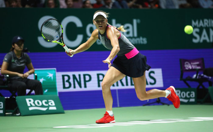Denmark’s Caroline Wozniacki in action during her group stage match with Romania’s Simona Halep. Picture: @WTA/Twitter.