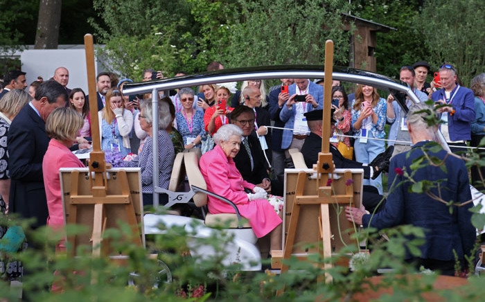 Britain's Queen Elizabeth II (C) is given a tour of the 2022 RHS Chelsea Flower Show in London on 23 May 2022. The Chelsea Flower Show is held annually in the grounds of the Royal Hospital Chelsea. Picture: Dan Kitwood/POOL/AFP