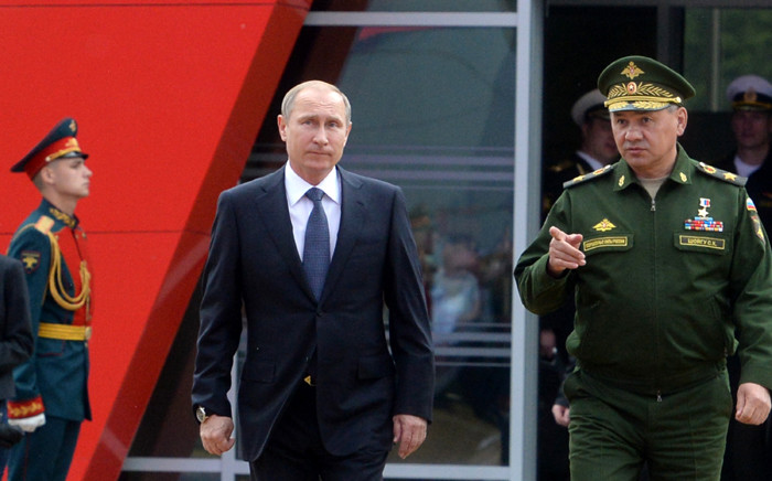 FILE. Russian President Vladimir Putin and Defence Minister Sergei Shoigu arrive for the opening of the Army-2015 international military forum in Kubinka, outside Moscow, on 16 June, 2015. Picture: AFP.