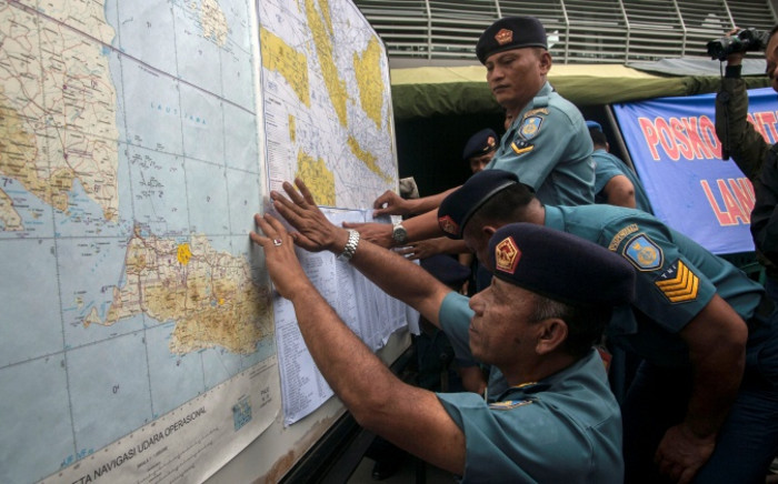 Indonesian Air Force officials show maps to journalists of the search area for the missing Malaysian air carrier AirAsia flight QZ8501, at the airport in Surabaya, East Java, on December 29, 2014. Picture: AFP.