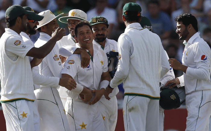 Pakistan's Yasir Shah (5L) is congratulated by team mates after taking the wicket of England's Jonny Bairstow for 48 runs on the fourth day of the first Test cricket match between England and Pakistan at Lord's cricket ground in London, on July 17, 2016. Picture: AFP