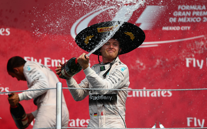 Nico Rosberg of Germany and Mercedes GP celebrates on the podium next to Lewis Hamilton of Great Britain and Mercedes GP after winning the Formula One Grand Prix of Mexico at Autodromo Hermanos Rodriguez on 1 November, 2015 in Mexico City, Mexico. Picture: AFP.