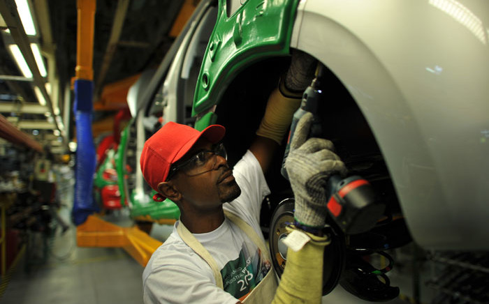 FILE: A worker on a car assembly line. Picture: AFP