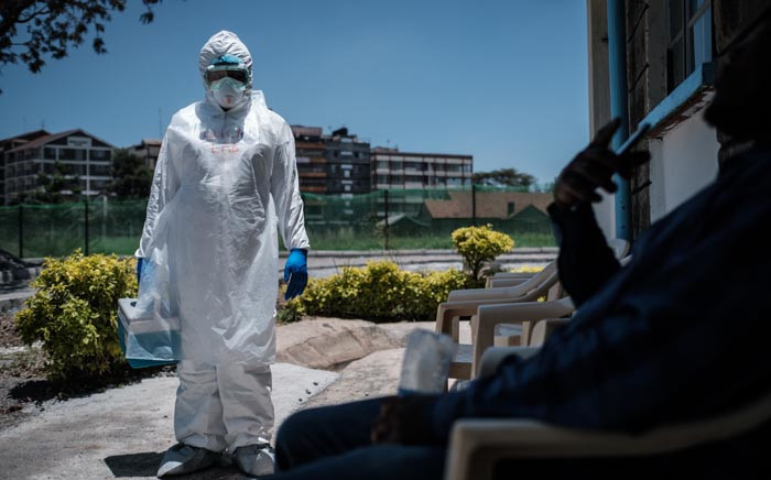 FILE: A laboratory specialist wearing protective gear outside the Infectious Disease Unit of Kenyatta National Hospital in Nairobi, Kenya, on 15 March 2020. Picture: AFP
