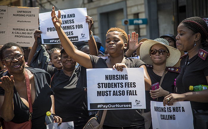 Nurses sing and raise their hands during a march by hundreds of nurses from across the country in central Pretoria for better pay and working conditions. Picture: Reinart Toerien/EWN