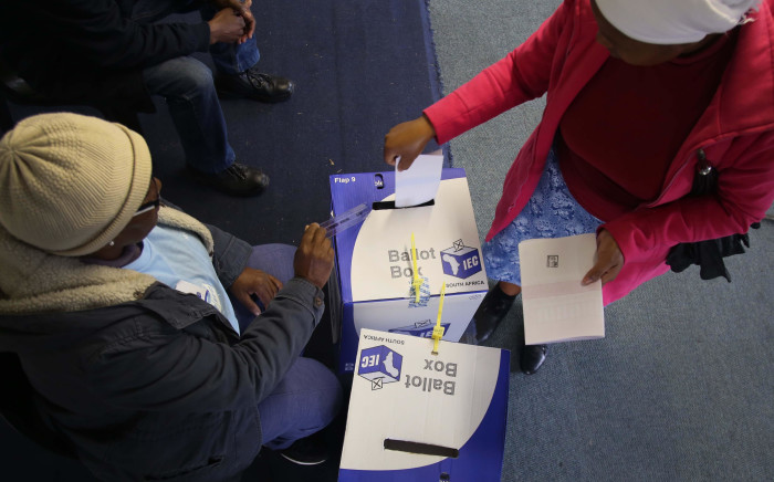 A voter places her marked ballots into the local and national ballot boxes on 8 May 2019. Picture: Bertram Malgas/EWN