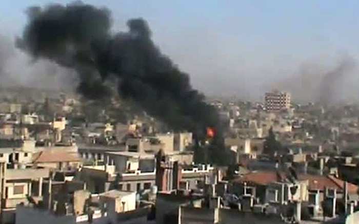 A screenshot from a video shows smoke blazing after an attack in the city of Homs on 11 June 2012. Picture: AFP