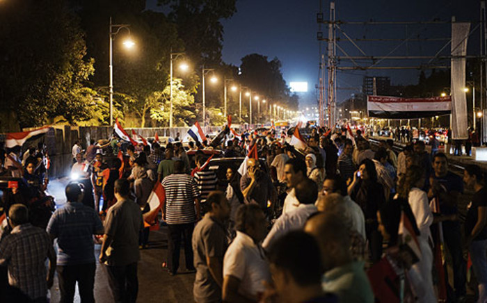 Hundreds of Egyptian protesters wave national flags and shout slogans against President Mohammed Morsi outside the presidential palace on 30 June 2013. Picture: AFP