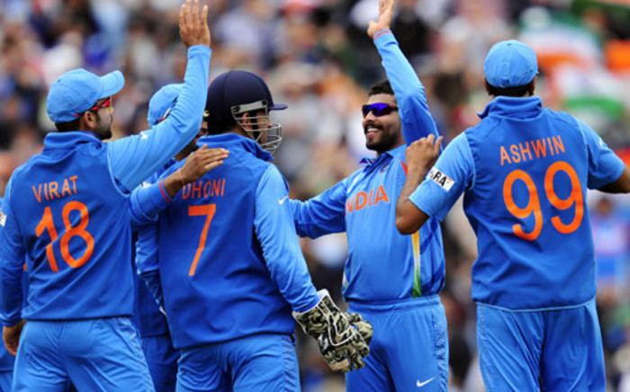The Indian cricket team celebrate after a wicket fall during their Champions Trophy match against the West Indies. Picture: AFP 