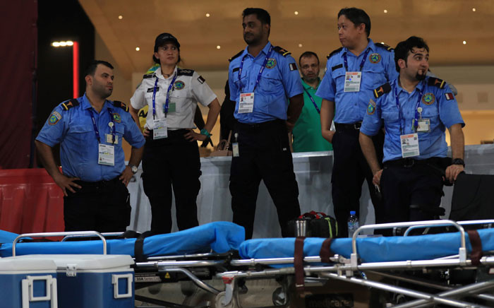 Members of the medical team watch as athletes compete in the Men's and Women's 50km Race Walk final at the 2019 IAAF World Athletics Championships in Doha on 29 September 2019. Picture: AFP