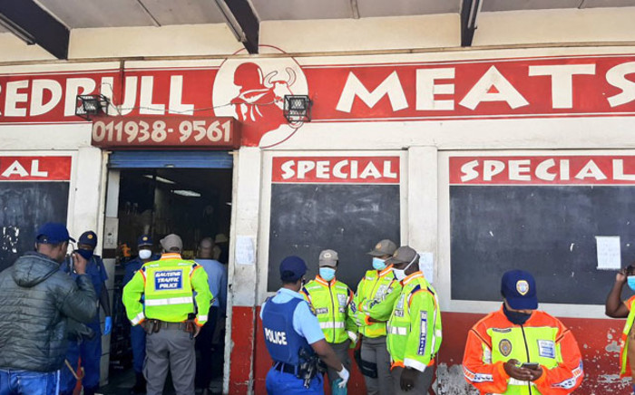 Members of the SAPS, Gauteng traffic police and the JMPD inspect a store in Soweto for compliance with lockdown regulations. Picture: @JoburgMPD/Twitter
