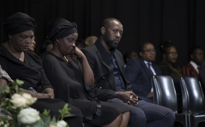 Enock Mpianzi's family sit quietly and sombre on stage during at a memorial service held at Parktown Boys' High. Picture: Xanderleigh Dookey/EWN