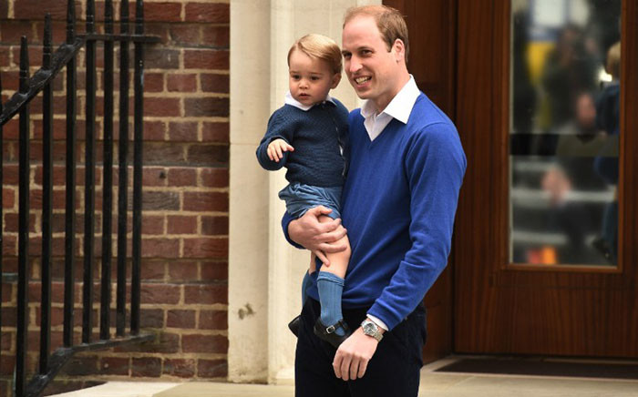 Britains Prince William, Duke of Cambridge (R), holds his son Prince George of Cambridge as they return to the Lindo Wing at St Mary's Hospital in central London, on 2 May, 2015 where his wife Catherine, Duchess of Cambridge, gave birth to their second child, a baby girl, earlier in the day. Picture: AFP.