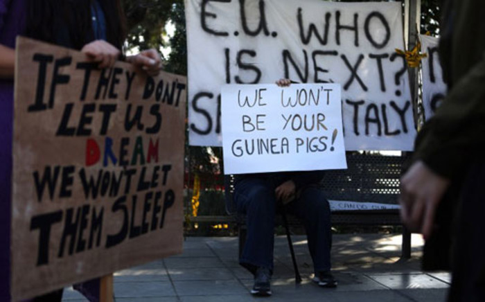 Cypriots hold placards during a protest against an EU bailout deal outside the parliament in Nicosia on March 18, 2013. Picture: AFP/ PATRICK BAZ