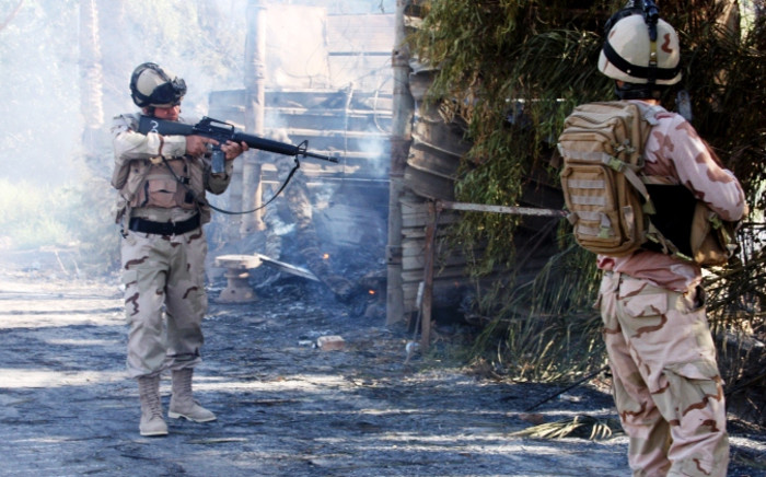 FILE: Iraqi soldiers advance through a village in 2014. Picture: AFP.