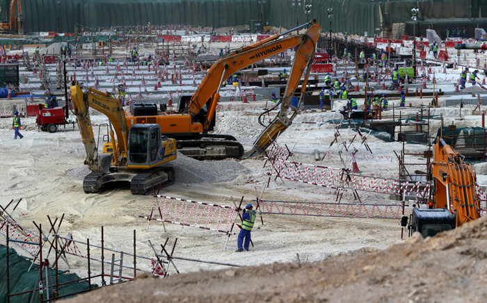 FILE: Foreign labourers work at the construction site of the al-Wakrah football stadium, one of the Qatar's 2022 World Cup stadiums, in May 2015. Picture: AFP.