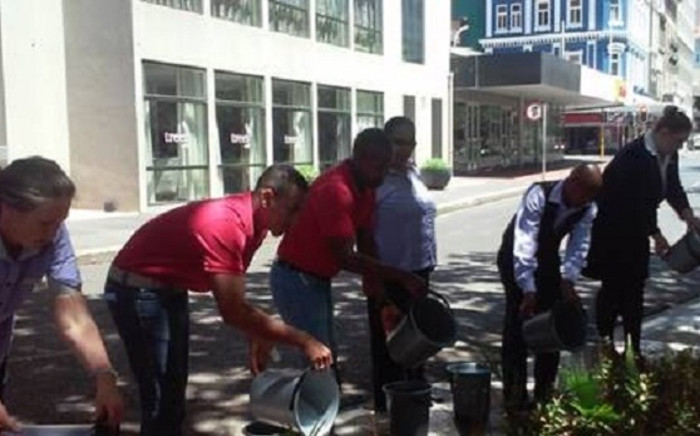 Staff at Townhouse Hotel using excess shower water for gardening. Picture: Supplied. 