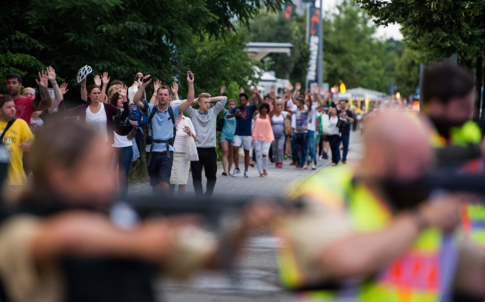 FILE: Police escorts evacuated people from the shopping mall in Munich on July 22, 2016 following a shooting that killed at least eight people. Picture: AFP.