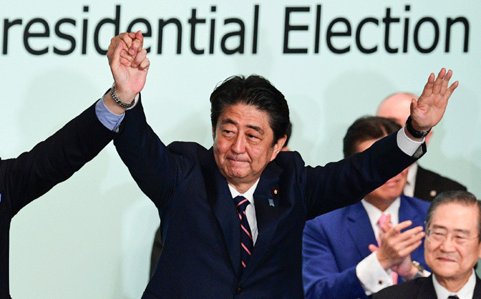 FILE: Japan's Prime Minister Shinzo Abe celebrates after the ruling liberal Democratic Party (LDP) leadership election at the party's headquarters in Tokyo on 20 September 2018. Picture: AFP.