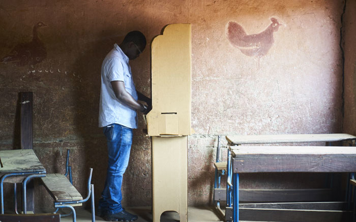 A man prepares to vote a polling station in Bamako on 12 August, 2018 during the second round of Mali's presidential elections. Picture: AFP