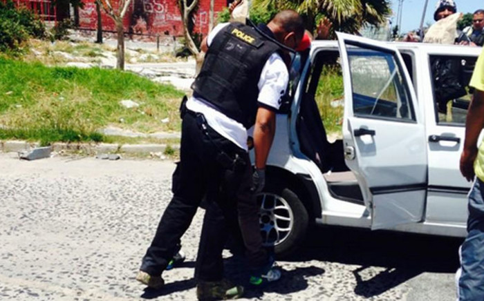 FILE: Cape Town police officers search suspects in Manenberg after gang warfare flares up on the Cape flats. Picture: Shamiela Fisher/EWN