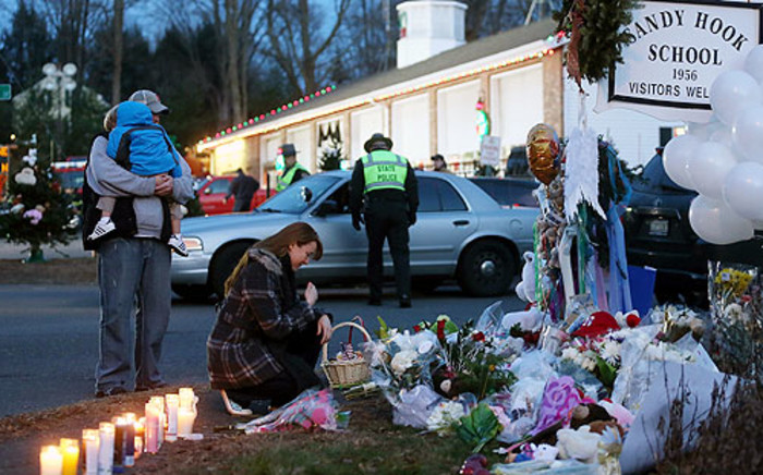 People gather at a makeshift memorial following the mass shooting at Sandy Hook Elementary School on December 15, 2012 in Newtown, Connecticut. Picture: AFP