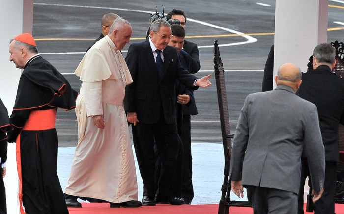 Pope Francis is welcomed by Cuban President Raul Castro (C) upon landing at Jose Marti international airport in Havana on 19 September, 2015. Picture: AFP.