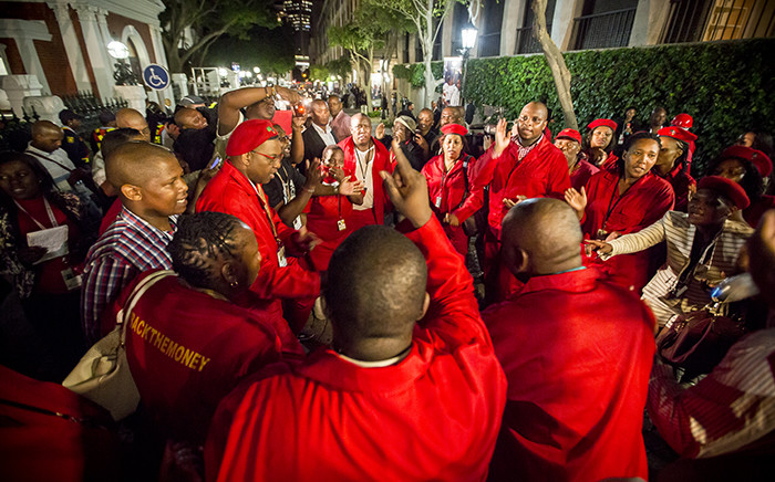 Julius Malema and other EFF members dance and sing at parliament after they were thrown out of the State of the Nation Address 2015. Picture: Thomas Holder/EWN