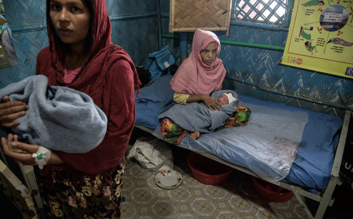 Rohingya refugees Zarina Begum (L), 20, and Latifa Begum (R), 30, hold their hours-old babies as they recover at an NGO-run maternity clinic in the Kutupalong refugee camp near Cox's Bazar. Picture: AFP.