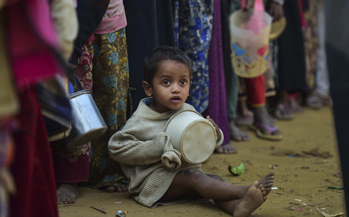 A Rohingya Muslim refugee waits with others for food aid at Thankhali refugee camp in Bangladesh's Ukhia district on 12 January 2018. Picture: AFP