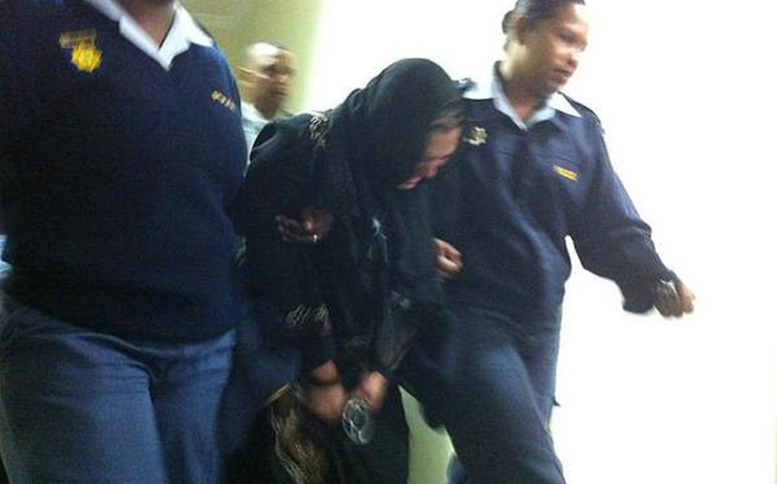Zulpha Jacobs is escorted out of court, after being sentenced to 20 years in prison for killing her son. Picture: Graeme Raubenheimer/EWN.