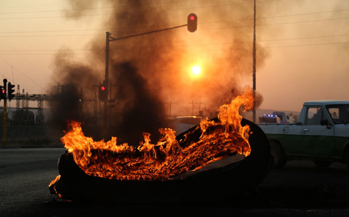 A tyre burns during a protest in Ennerdale, south of Johannesburg. Picture: Christa Eybers/EWN