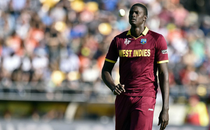 West Indies' captain Jason Holder walks back to bowl during the Cricket World Cup quarter-final match between New Zealand and the West Indies in Wellington on 21 March, 2015. Picture: AFP