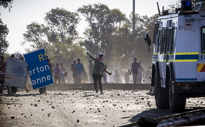 Protesters from Sicelo informal settlement, Meyerton, in the Midvaal hurl stones at an Nyala during a service delivery protest. Picture: Thomas Holder/EWN
