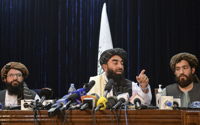 Taliban spokesperson Zabihullah Mujahid (C) gestures as he addresses the first press conference in Kabul on 17 August 2021 following the Taliban stunning takeover of Afghanistan. Picture: Hoshang Hashimi/AFP