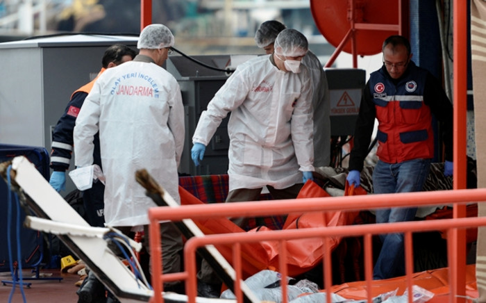 Medics carry the body of a migrant after a boat accident off Rumeli Feneri, at the Black Sea coast of Istanbul, Turkey, 03 November 2014. At least 24 people were killed after a boat carrying migrants capsized off the coast of northern Istanbul on 03 November, the Coast Guard said according to local media. Picture: EPA.