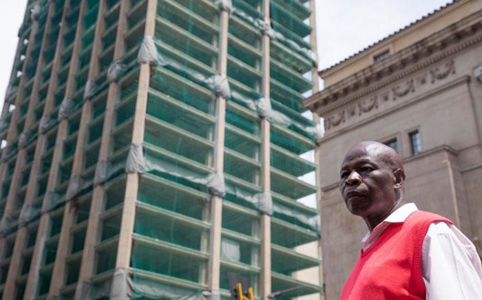 Robert Moropana stands near the Bank of Lisbon building in Johannesburg where his son, Joburg firefighter Simphiwe Moropana, died in a fire in 2018. The building is set to be demolished on 24 November 2019. Picture: Christa Eybers/EWN